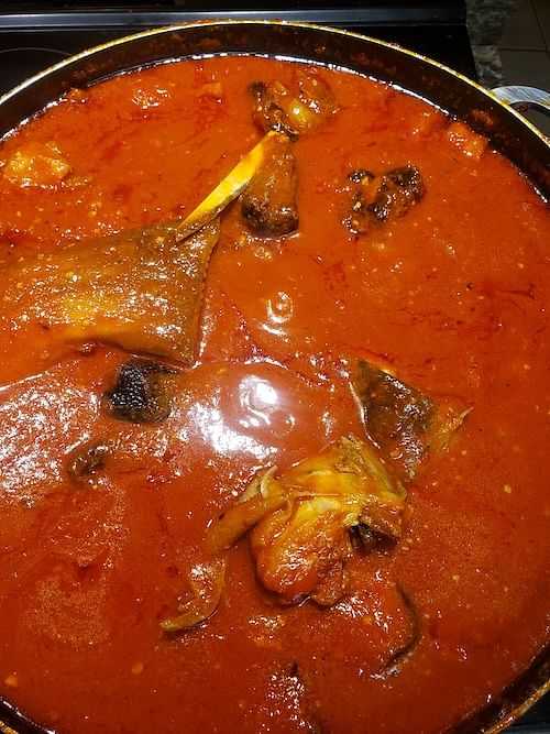 A pot of traditional spicy red stew with meat and vegetables.